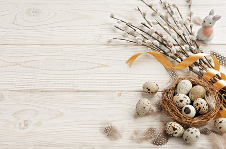 Easter background with Easter eggs and spring flowers. Top view with copy space.の写真素材