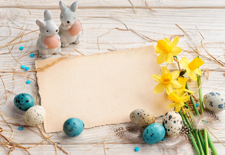 Easter background with Easter eggs and spring flowers. Top view with copy space.の写真素材