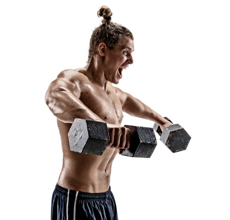 Muscular bodybuilder exercising. Photo of man working out with heavy dumbbells on white background. Side viewの写真素材