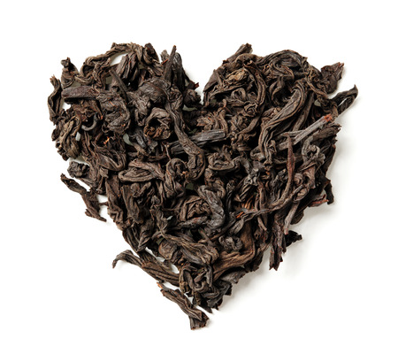 Heart shaped from black leaf tea isolated on white background. Top view. Close up. High resolutionの写真素材