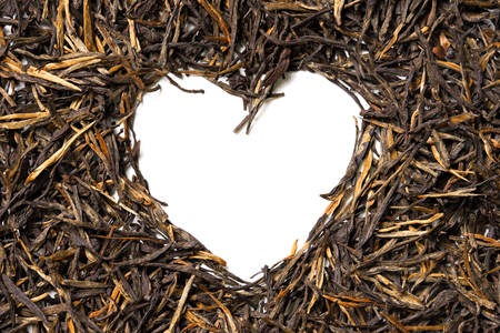 Heart shaped from black tea on white background. Top view. Close up. High resolutionの写真素材