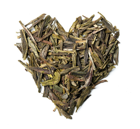 Heart shaped from green tea isolated on white background. Top view. Close up. High resolutionの写真素材