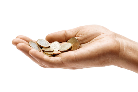 Man's hand holding a heap of different coins isolated on white background. Close up. High resolution product. Business conceptの写真素材