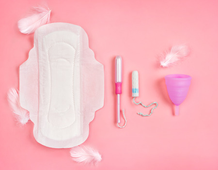 Sanitary napkin, tampons and menstrual cup on pink background. Concept of critical days, menstruationの写真素材