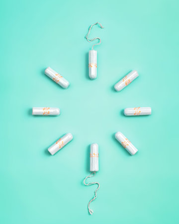 Tampons on turquoise background. Concept of critical days, menstruation