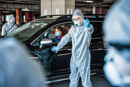 Man in protective suit calls for help, woman in car is sick