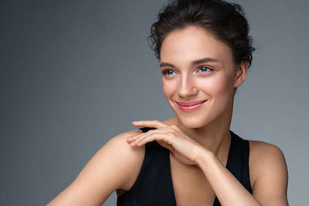Beautiful woman with perfect makeup on gray background. Beauty and skin care conceptの写真素材