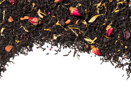 Black tea with ose buds, cherry pieces and cinnamon on white background. close up. high resolutionの写真素材