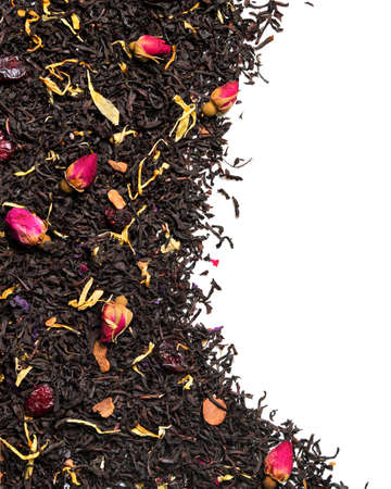 Black tea with ose buds, cherry pieces and cinnamon on white background. close up. high resolutionの写真素材