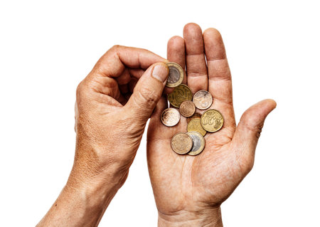 Male hands hold alms or last money, counting euro coins isolated on white backgroundの写真素材