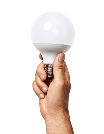 Man's hand holds LED light bulb isolated on white backgroundの写真素材