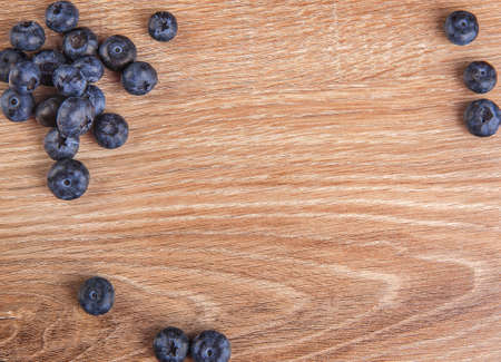 Structure of blueberries on a wooden background. Creative blueberry top view, flat layoutの写真素材
