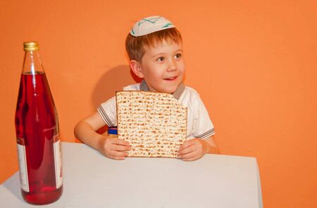 Happy little Jewish child with a kippah on his head looking forward for the Jewish holiday of Pessach. Passover illustration.の写真素材