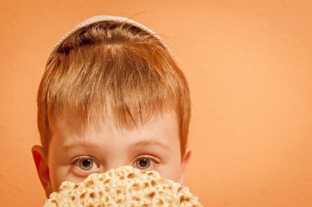 Happy little Jewish child with a kippah on his head looking forward for the Jewish holiday of Pessach. Passover illustration.の写真素材