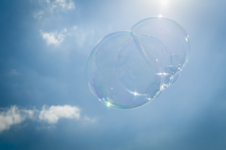 Soap bubble in the sky stock image. Illusions concept illustrative, loss, unstable, volatile, sandy.の写真素材