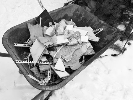 Repair construction and construction waste in a construction cart on snow in winter