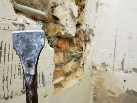 a drill from a perforator, a chisel and a strobe in a brick wall and a propylene pipe - plumbing in the bathroomの写真素材