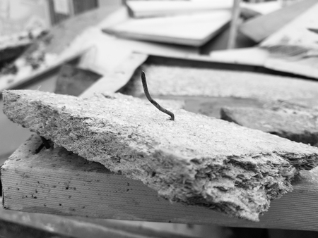 nails and old boards in a pile of construction waste after repairの写真素材