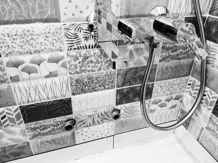 Repair and plumbing - water tap on a tile in the bathroom