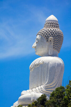 The big Buddha statue closeup on the background of blue skyの写真素材