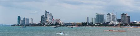 Pattaya coast panorama, Thailand. A cloudy day, along the coast there are many large, modern buildings, various boats can be seen on the water.の写真素材