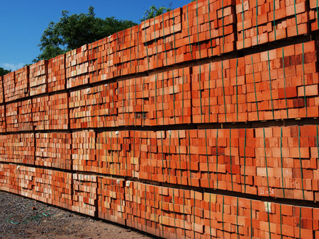 Just made red bricks stacked in several rows for sale