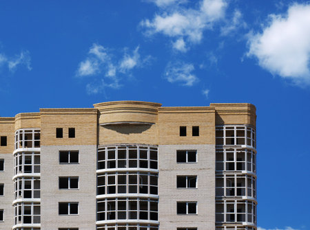 New multi-storey building construction on a background of blue sky