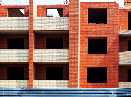 Multistory building from brick under construction closeupの写真素材