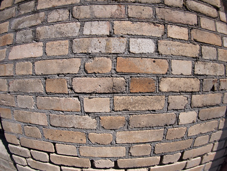 Old wall from gray and brown bricks close up with wide angle fisheye lens viewの写真素材