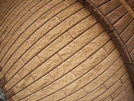 Fragment of decorative brickwork brown with wide angle distortion viewの写真素材