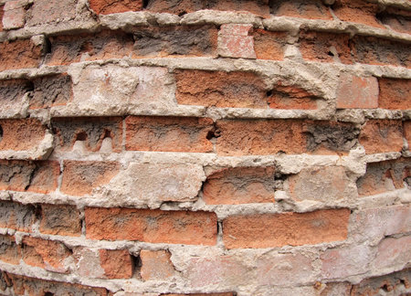 Fragment of the old wall of the destroyed bricks with wide angle distortion view closeup