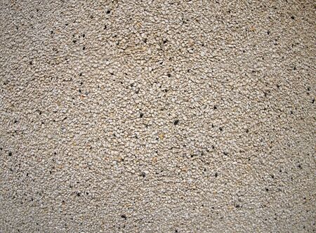 Detail of a wall made of small gray and black stonesの写真素材