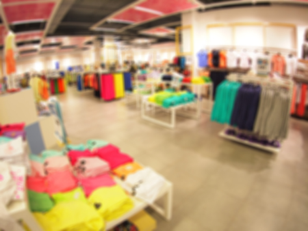 Defocused and blurry image of the interior of a clothing store with wide angle distortion view was blurred for use as a backgroundの写真素材