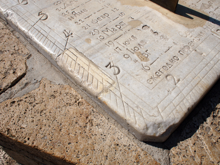 Detail of ancient stone dial sundial closeup. On the white marble slab engraved numbers and names of the months in Russianの写真素材