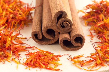 Macro view of the sticks of cinnamon and saffron close-up with shallow depth of field