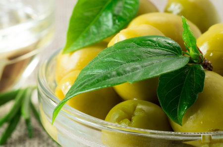 Macro view of the olives with green leaves close-up with shallow depth of focusの写真素材