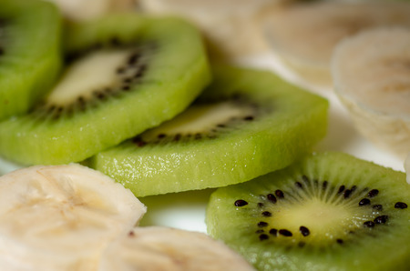 Pieces of kiwi and banana close-up with shallow depth of fieldの写真素材