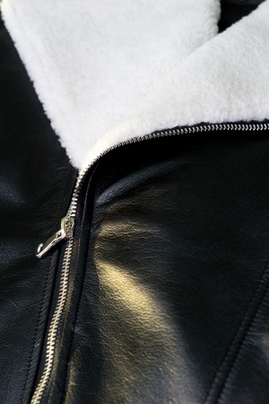 Silver zipper on black leatherの写真素材