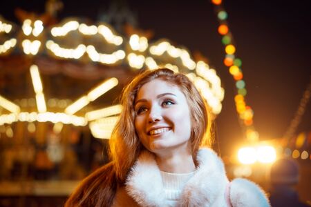 red-haired girl on the background carouselの写真素材