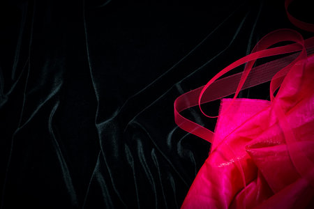 pink fabric on a black velvet backgroundの写真素材