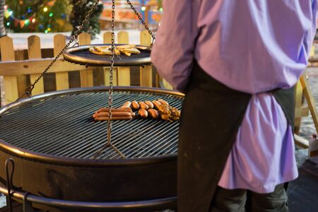 Grilling sausages on barbecue grill. Selective focusの写真素材