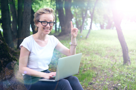 girl geek in the forest with the computerの写真素材
