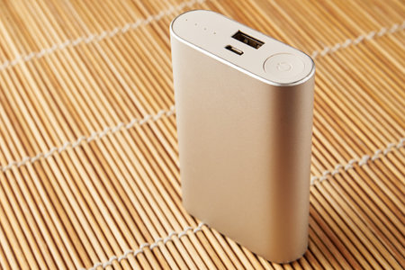 gray powerbank on wooden background