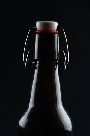 black bottle with a cap on a dark backgroundの写真素材