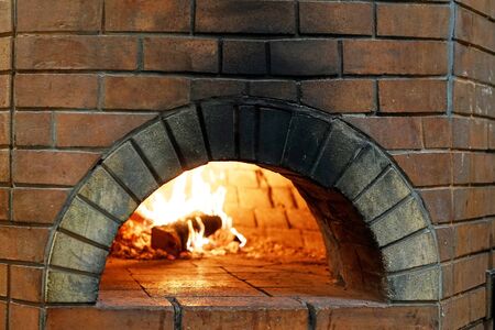 wood-burning oven with burning woodの写真素材