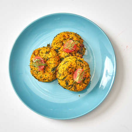 Vegetarian vegetable carrot cutlets on a blue plate with dill and tomatoes