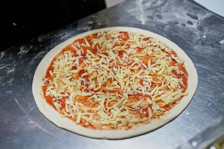 The chef prepares pizza with his handsの写真素材