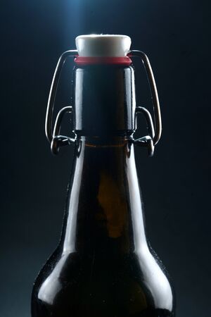 beer bottle with lid dark glass on a dark backgroundの写真素材