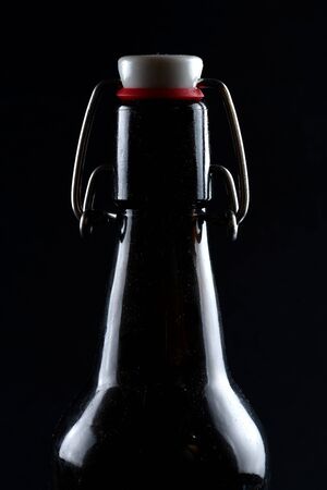 beer bottle with lid dark glass on a dark backgroundの写真素材