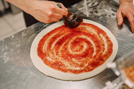 the chef in the kitchen prepares pizza